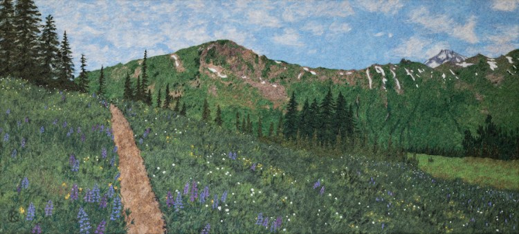 Felted wool artwork of a trail through a lupine meadow, with a mountain ridge line in the background