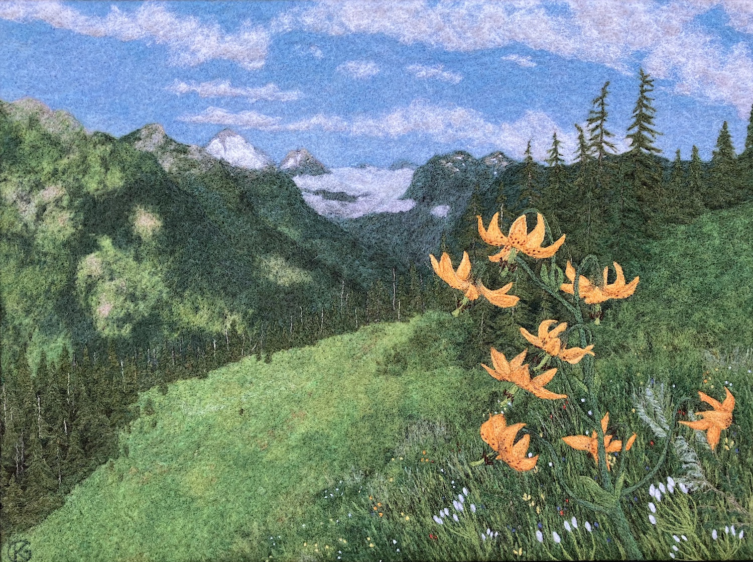 Felted wool artwork of a stem of orange Columbia lilies, with a mountain landscape in the background.